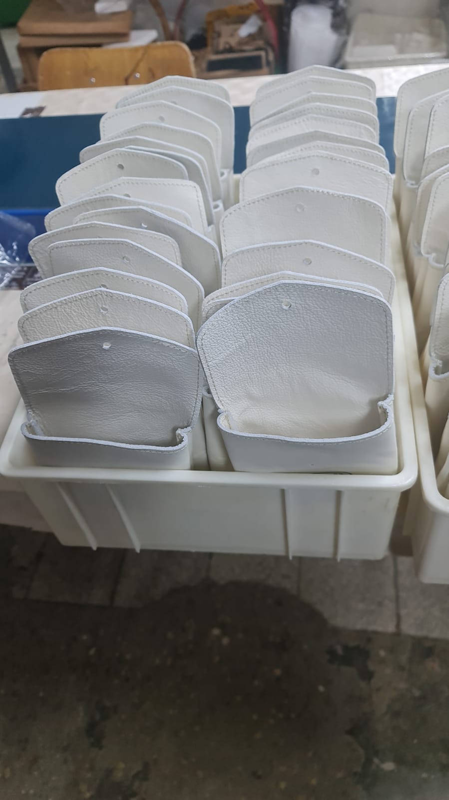 White leather cases for the metal playing pieces during production.